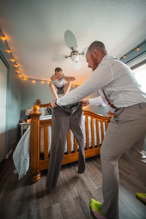 Groomsman leaping onto the bed, getting ready