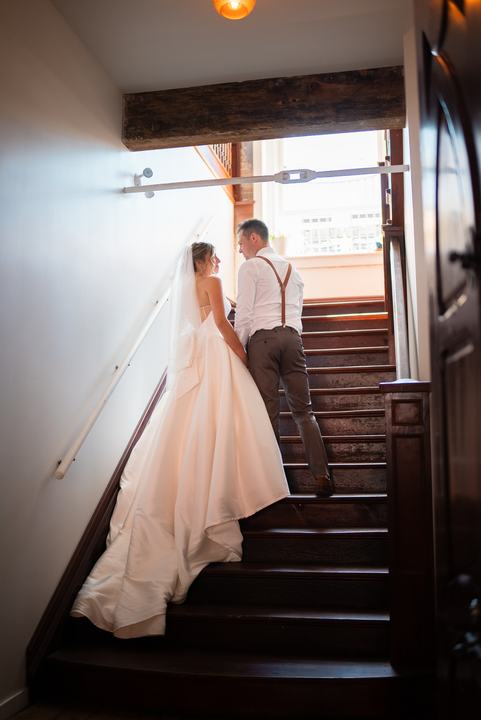 Bride and groom walking up the staircase