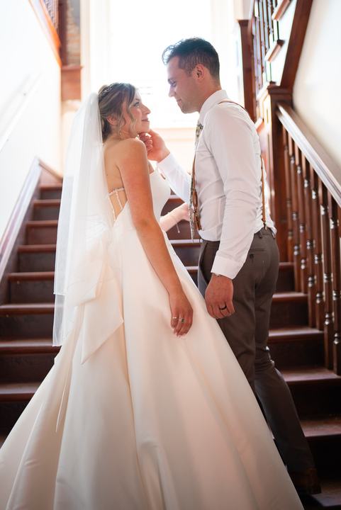 Couple laughing at the foot of the stairs